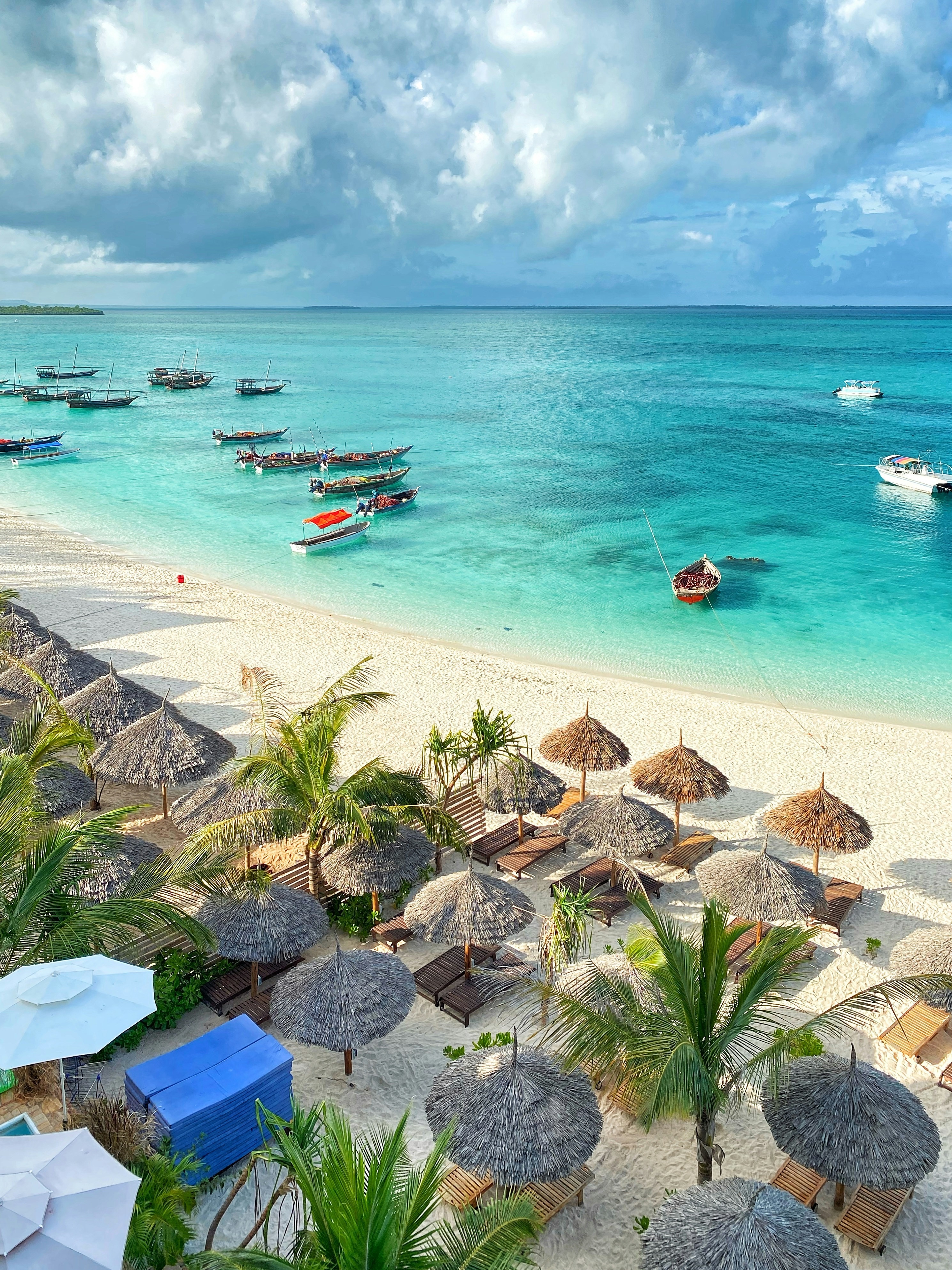 Zanzibar turquoise beach with umbrellas and boats